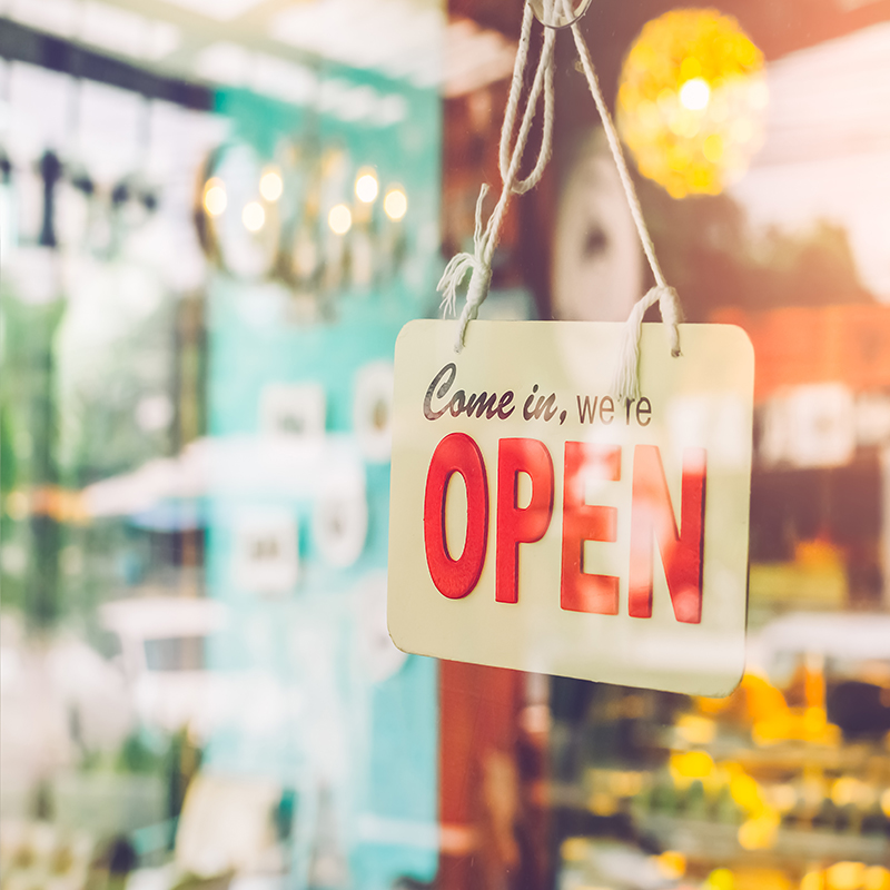 Open sign broad through the glass of door in cafe. Business service and food concept. Vintage tone filter color style.